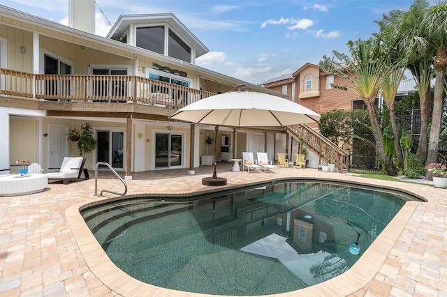 swimming pool featuring a patio area and stairway