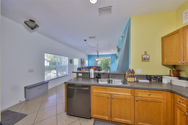 kitchen featuring a peninsula, a sink, dark countertops, visible vents, and dishwasher