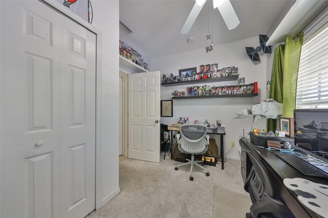 office area with visible vents, carpet flooring, baseboards, and a ceiling fan