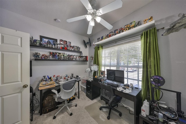 carpeted office space featuring ceiling fan