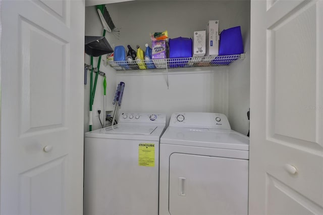 laundry room with washing machine and clothes dryer and laundry area