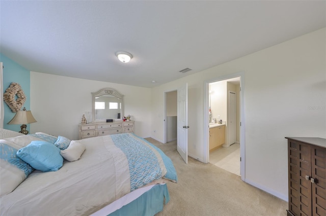 bedroom with light colored carpet, baseboards, ensuite bathroom, and visible vents