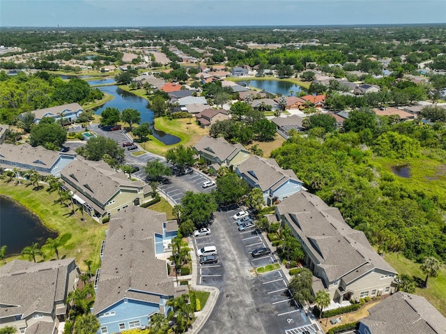 drone / aerial view with a water view and a residential view