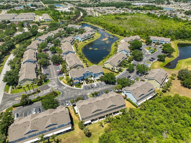 birds eye view of property with a water view and a residential view