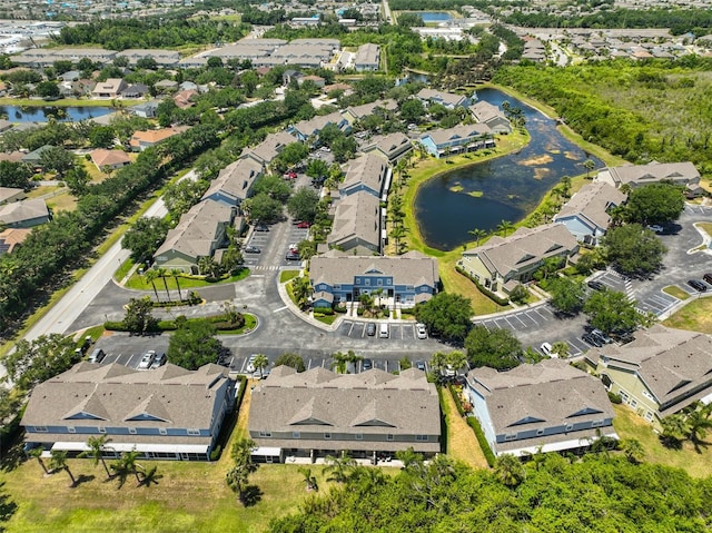 drone / aerial view featuring a residential view and a water view