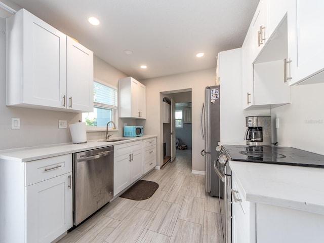 11397 122nd Ave, Largo, FL 33778 - kitchen with appliances with stainless steel finishes, a sink, white cabinets, light countertops, and recessed lighting