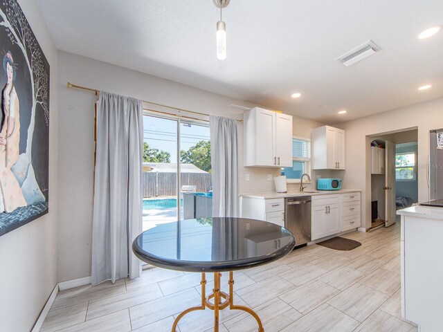 11397 122nd Ave, Largo, FL 33778 - kitchen with dishwasher, white cabinets, light countertops, a sink, and recessed lighting