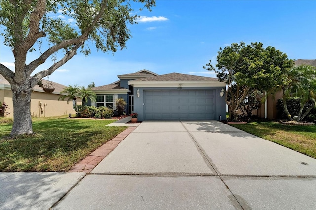 single story home featuring a garage, stucco siding, driveway, and a front yard
