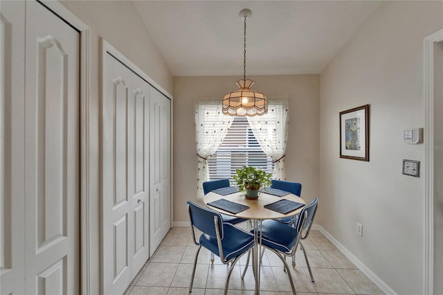 dining room featuring baseboards and light tile patterned floors