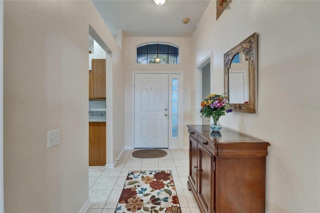 entrance foyer featuring baseboards and light tile patterned floors