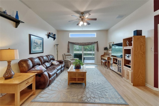 living area with light wood-type flooring, baseboards, ceiling fan, and visible vents