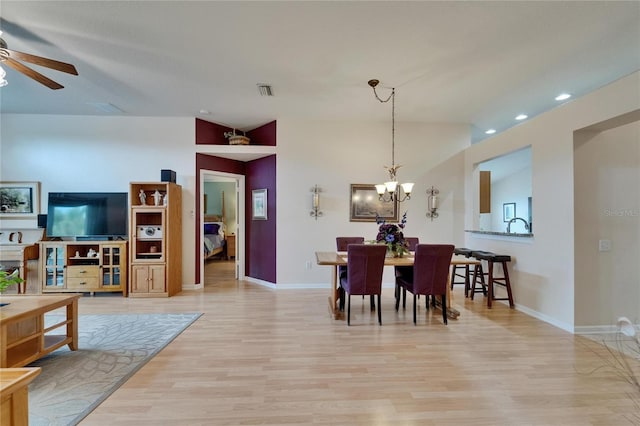 dining room with recessed lighting, baseboards, ceiling fan with notable chandelier, and light wood-type flooring