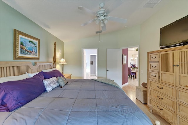 bedroom with visible vents, a ceiling fan, light wood-style flooring, and lofted ceiling