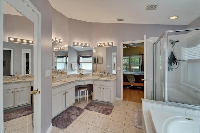 bathroom with visible vents, tile patterned flooring, a shower stall, a sink, and vaulted ceiling