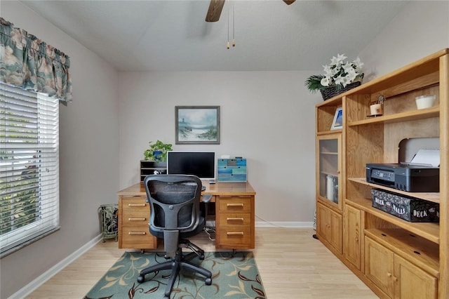 office area featuring light wood-type flooring, baseboards, and ceiling fan
