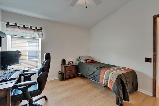 bedroom featuring baseboards, vaulted ceiling, ceiling fan, and light wood finished floors