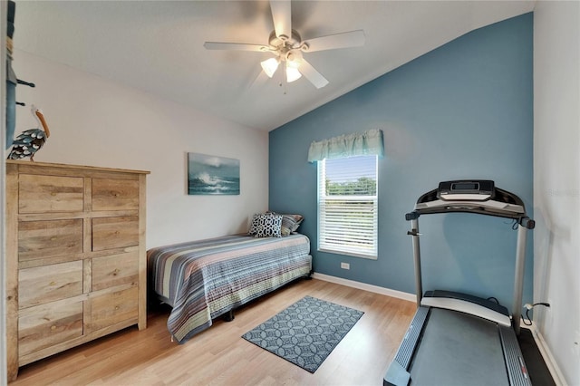 bedroom featuring baseboards, a ceiling fan, wood finished floors, and lofted ceiling