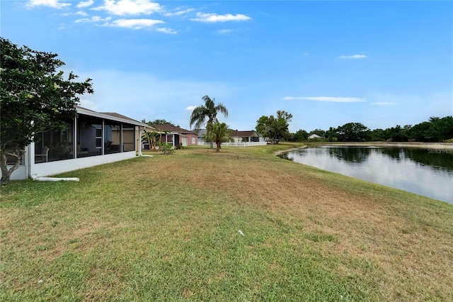 view of yard with a water view and a sunroom