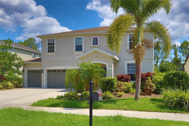 view of front of home featuring stucco siding, driveway, and a garage