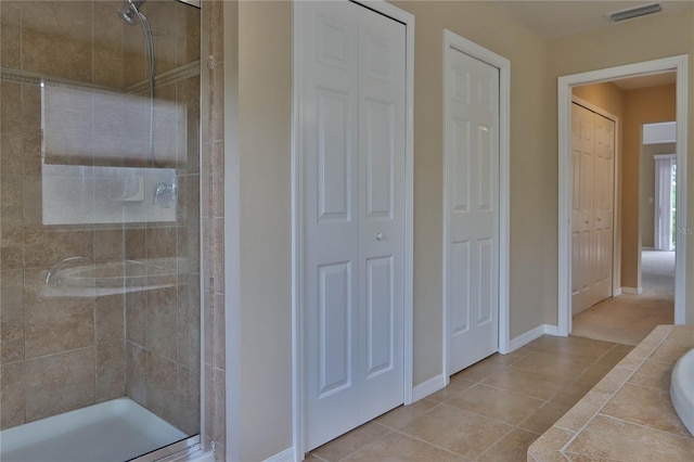 full bathroom with visible vents, a shower stall, and a closet
