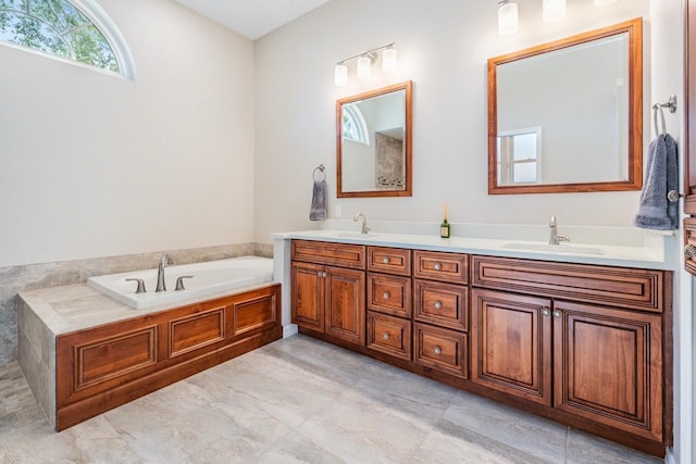 full bathroom featuring a garden tub, a sink, and double vanity