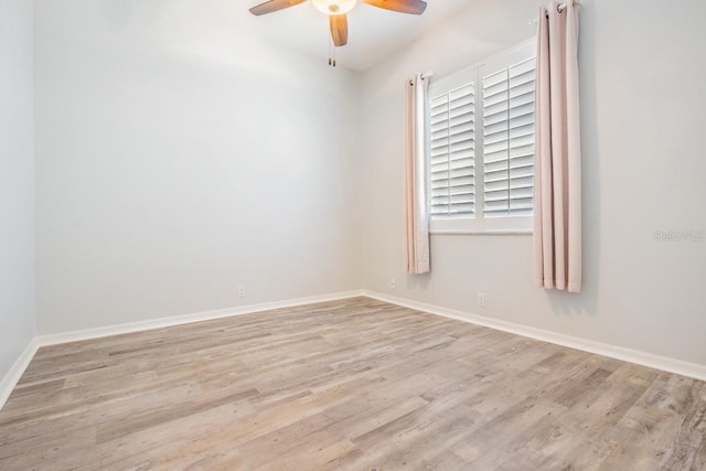 spare room featuring wood finished floors, baseboards, and ceiling fan