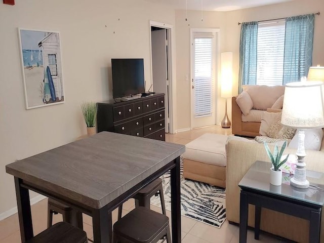 living room featuring light tile patterned flooring and baseboards