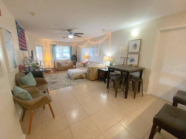 living room with light tile patterned floors and a ceiling fan