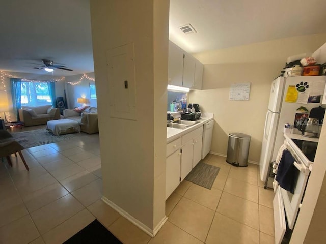 kitchen with a sink, white electric range oven, light tile patterned floors, visible vents, and light countertops