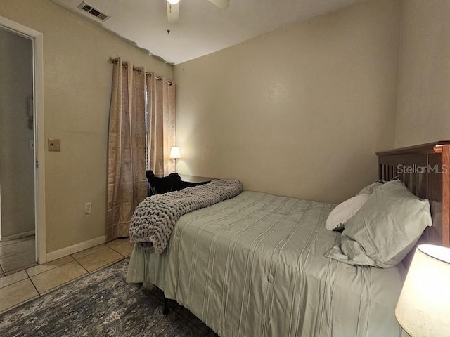 tiled bedroom with a ceiling fan and visible vents