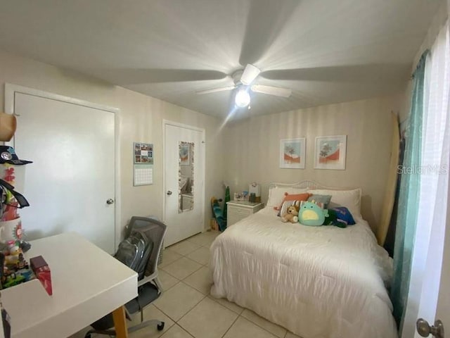 bedroom featuring light tile patterned floors and ceiling fan