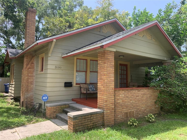 3100 11th Ave N, Saint Petersburg, FL 33713 - bungalow-style home featuring a chimney, a porch, and brick siding