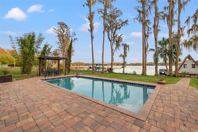 pool with a yard, a pergola, a water view, and a patio area