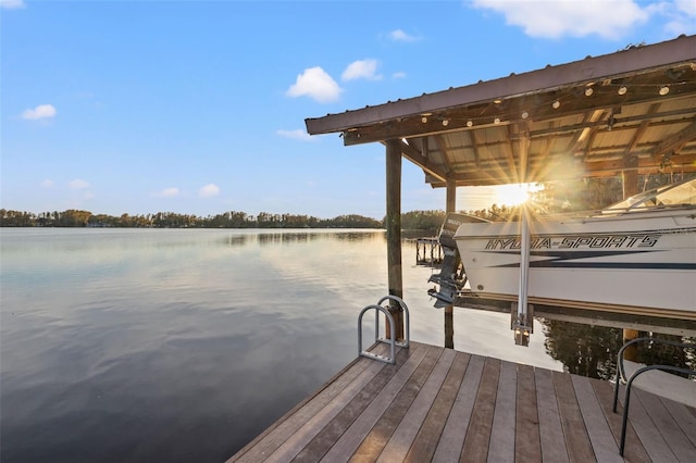 dock area with boat lift and a water view