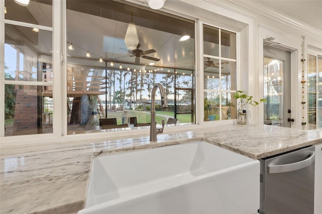 interior space with a healthy amount of sunlight, stainless steel dishwasher, ceiling fan, and a sink