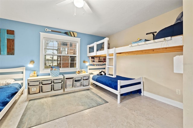 bedroom with a ceiling fan and baseboards