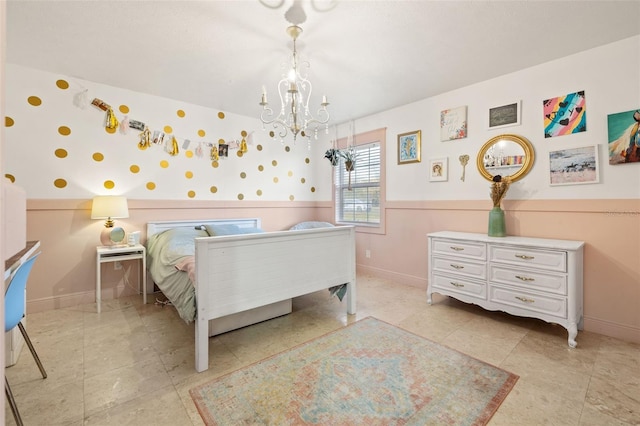 tiled bedroom featuring baseboards and a chandelier