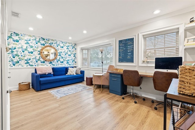 office featuring wallpapered walls, light wood finished floors, visible vents, ornamental molding, and wainscoting