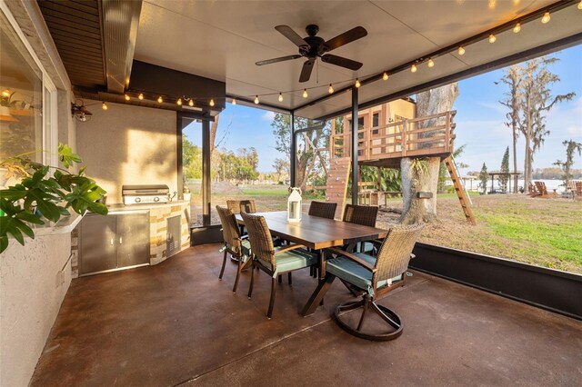 sunroom featuring an outdoor kitchen, outdoor dining area, ceiling fan, and floor to ceiling windows