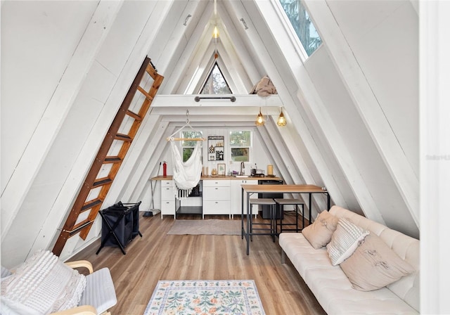 interior space featuring light wood-style flooring and high vaulted ceiling