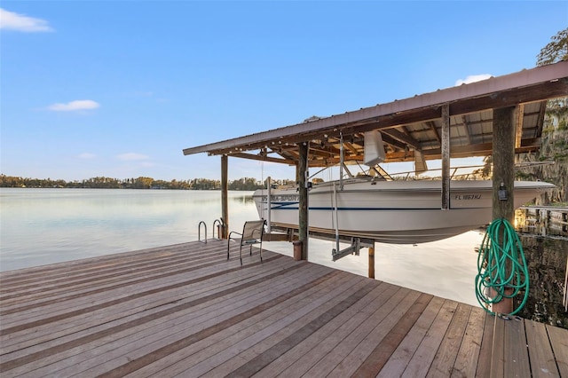 dock area featuring boat lift and a water view