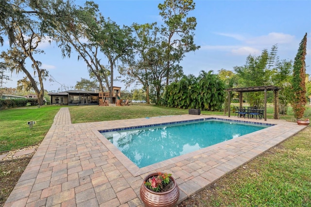 pool featuring a pergola, a lawn, and a patio area