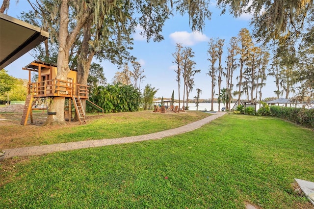 view of yard featuring a playground and a water view