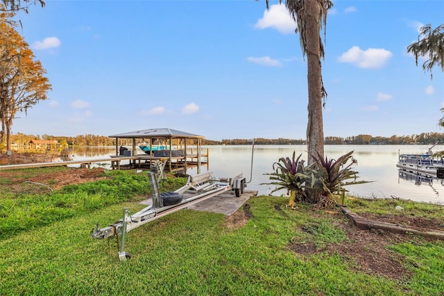 view of dock with boat lift and a water view