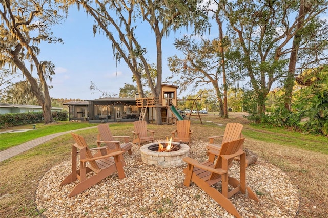 exterior space featuring a fire pit and a yard