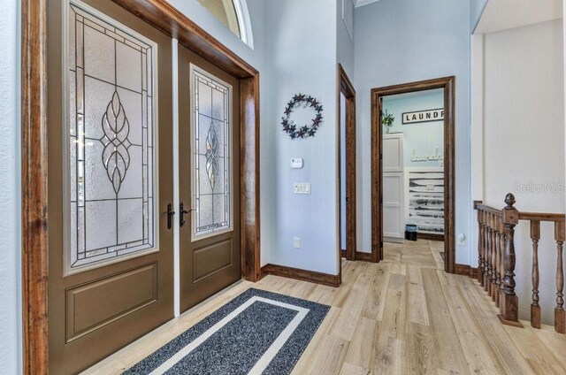 107 Sunset Dr, Nokomis, FL 34275 - foyer entrance featuring light wood-style flooring, baseboards, and a healthy amount of sunlight