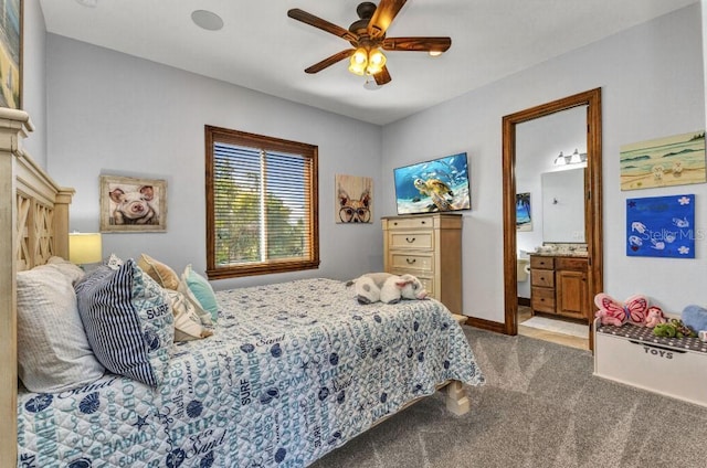 107 Sunset Dr, Nokomis, FL 34275 - carpeted bedroom with baseboards, a ceiling fan, and ensuite bath