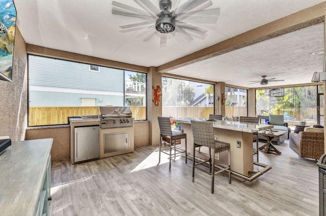 107 Sunset Dr, Nokomis, FL 34275 - sunroom / solarium featuring a wooden deck, wood finished floors, a textured ceiling, and plenty of natural light