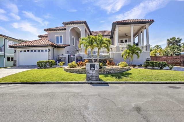 107 Sunset Dr, Nokomis, FL 34275 - mediterranean / spanish home with a tile roof, a front yard, and stucco siding