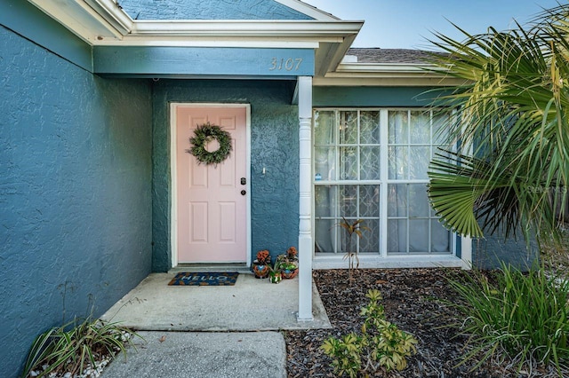 doorway to property with stucco siding